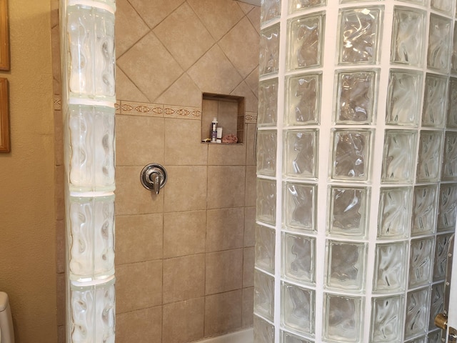 bathroom with a tile shower