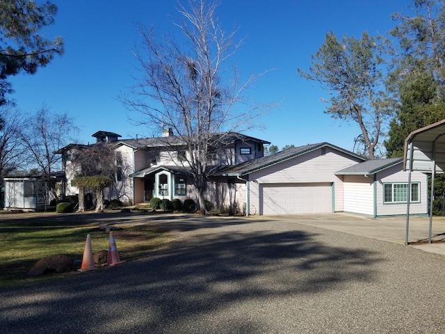 view of front of house featuring a carport and a garage