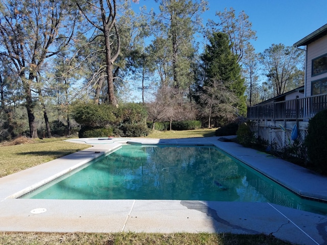 view of pool with a lawn