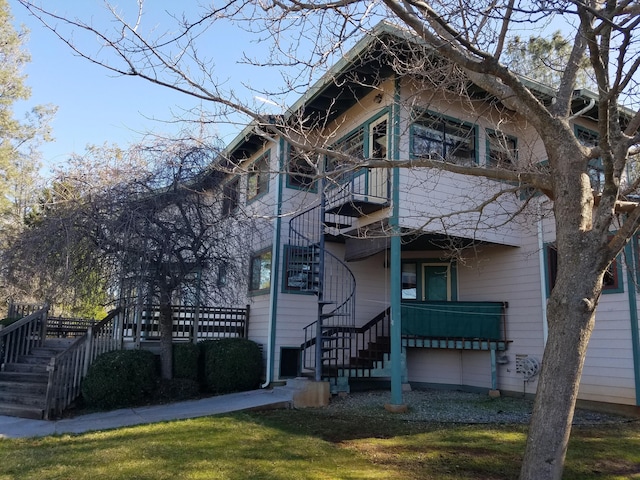 exterior space with a yard and a balcony