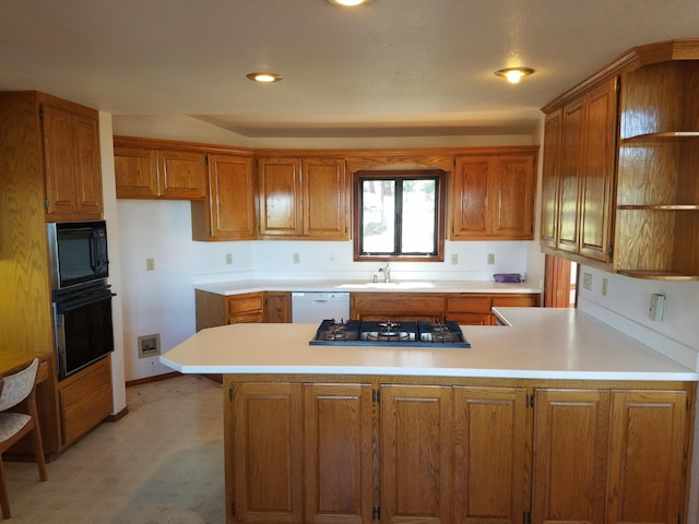 kitchen featuring kitchen peninsula, sink, and black appliances