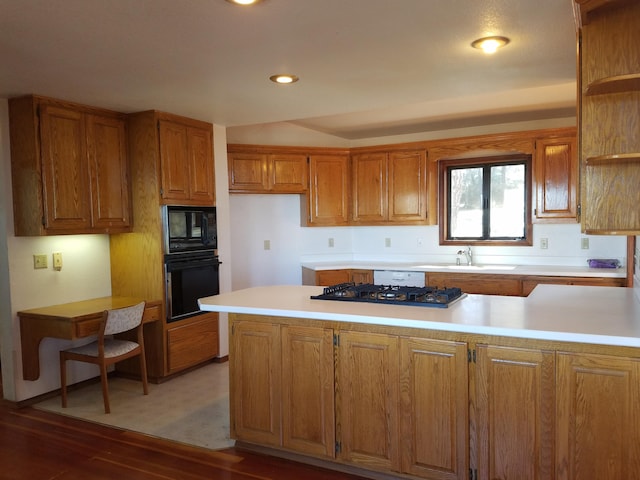 kitchen featuring sink, dark wood-type flooring, and black appliances