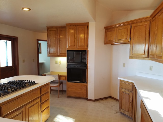 kitchen with lofted ceiling and black appliances