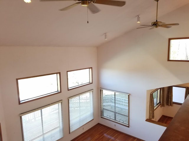 unfurnished living room featuring hardwood / wood-style floors, high vaulted ceiling, and ceiling fan