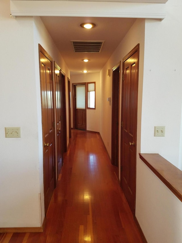 hallway featuring dark hardwood / wood-style floors