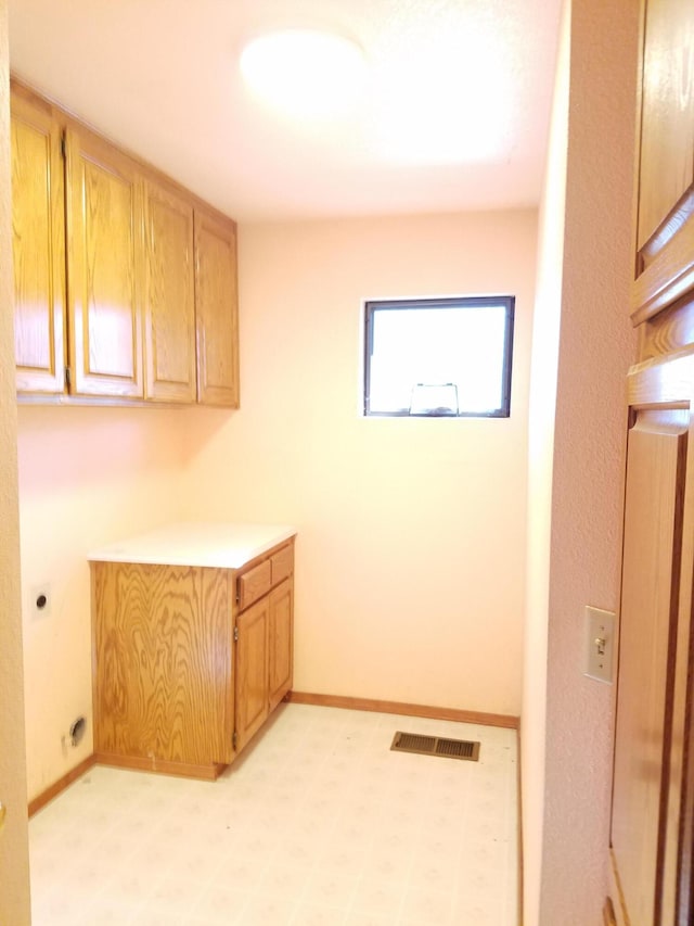 laundry area featuring cabinets and electric dryer hookup