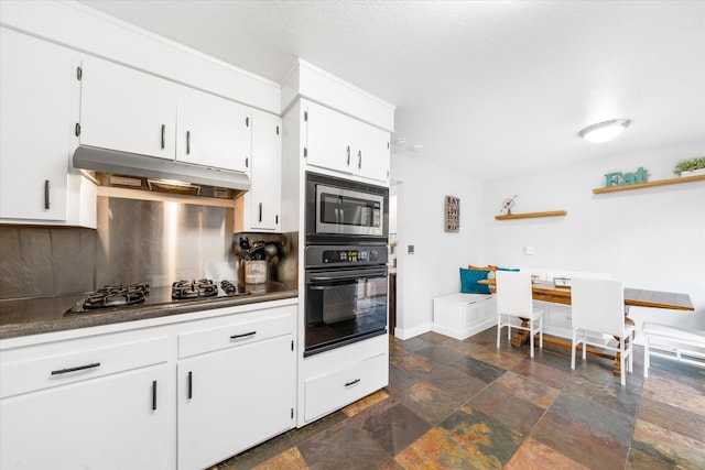 kitchen featuring appliances with stainless steel finishes, decorative backsplash, and white cabinets