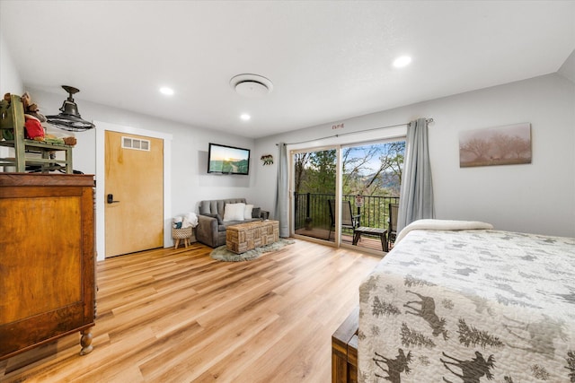 bedroom with wood-type flooring and access to exterior