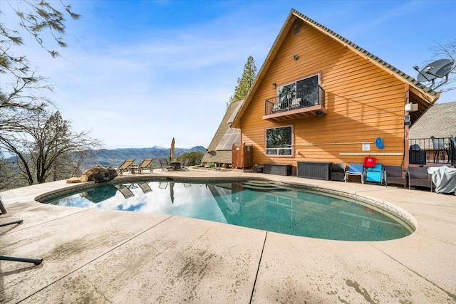 view of pool with a mountain view and a patio area