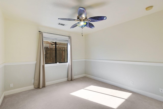 empty room with ceiling fan and light carpet