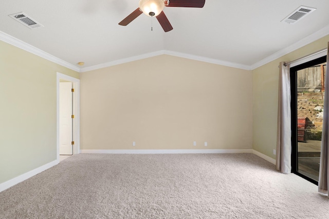 empty room featuring crown molding, vaulted ceiling, light carpet, and ceiling fan