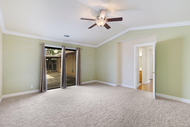 carpeted empty room featuring ceiling fan, ornamental molding, and lofted ceiling