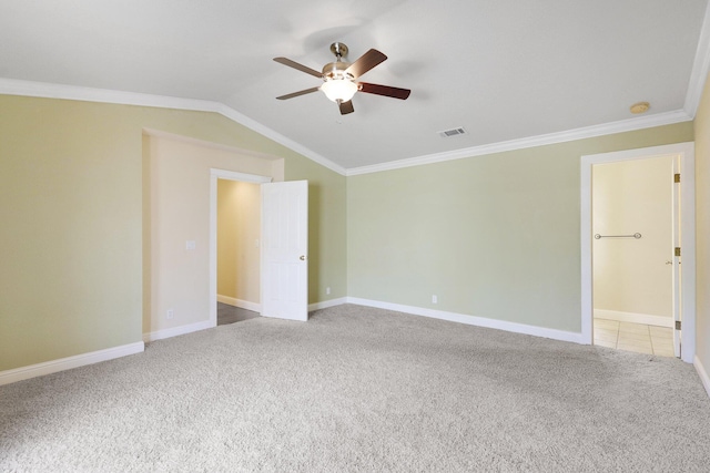 spare room featuring vaulted ceiling, ornamental molding, ceiling fan, and carpet flooring