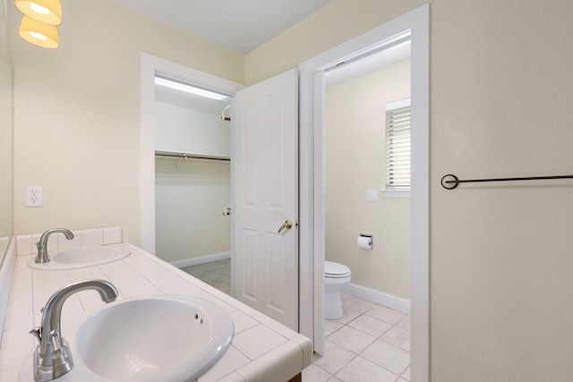 bathroom featuring tile patterned flooring, vanity, and toilet