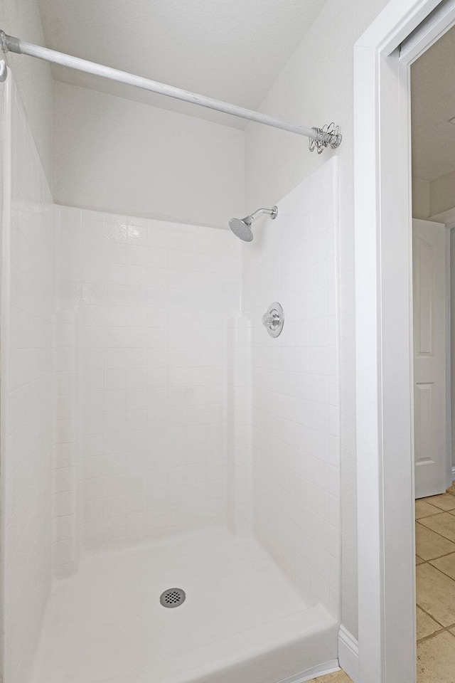 bathroom with a shower and tile patterned floors