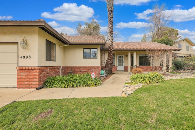 ranch-style house with a garage and a front lawn