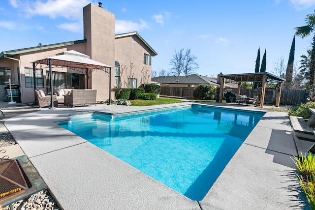 view of swimming pool featuring a gazebo, outdoor lounge area, and a patio