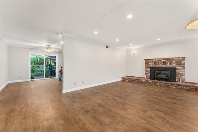 unfurnished living room with ceiling fan, ornamental molding, dark hardwood / wood-style flooring, and a brick fireplace