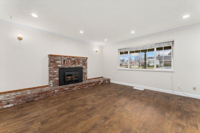 unfurnished living room featuring ornamental molding, a brick fireplace, and dark hardwood / wood-style floors