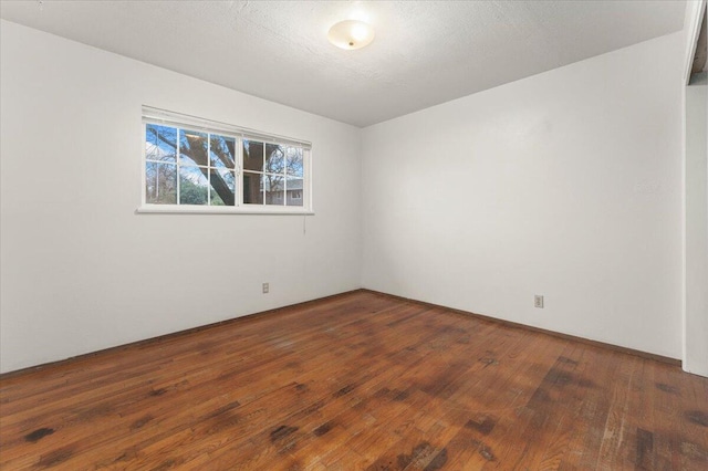 spare room with dark hardwood / wood-style floors