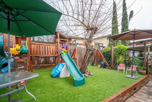 view of playground with a lawn