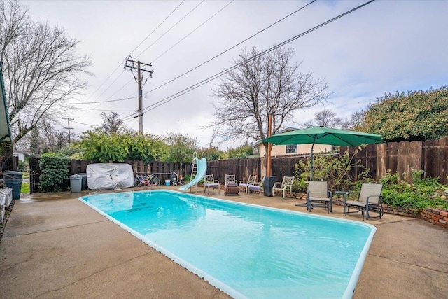 view of pool featuring a patio and a water slide