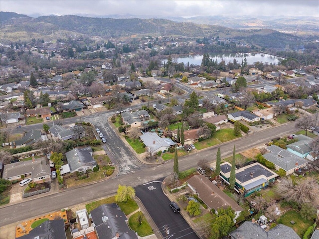 birds eye view of property with a water and mountain view