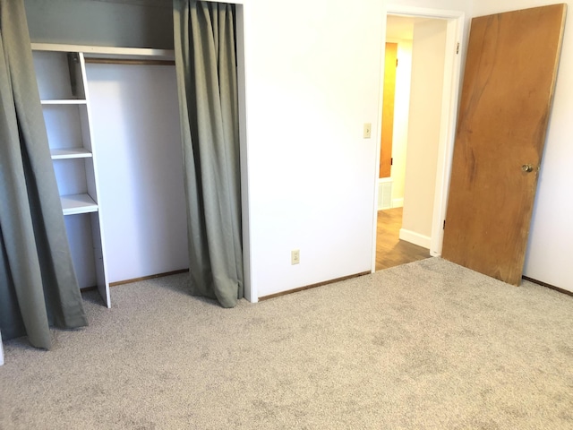 unfurnished bedroom with baseboards and carpet flooring