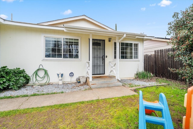 bungalow-style house with fence