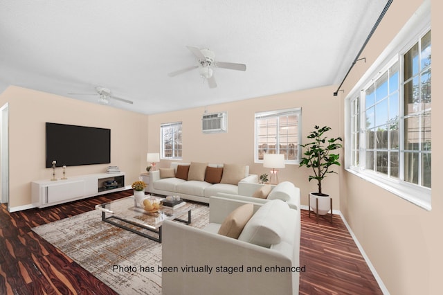 living room featuring baseboards, dark wood-style flooring, a wealth of natural light, and a wall mounted AC