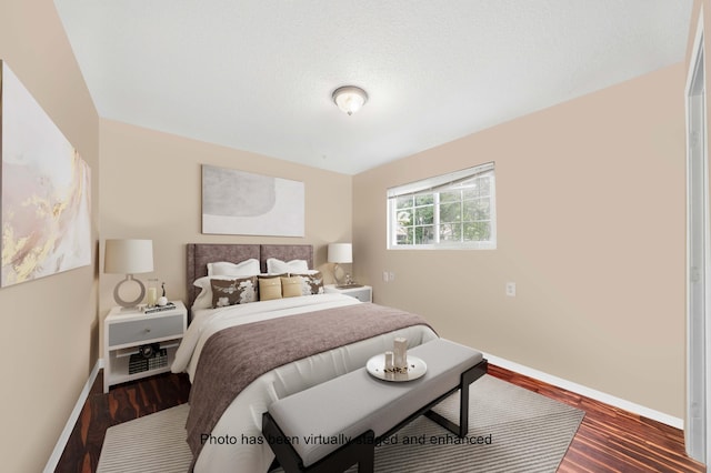 bedroom featuring a textured ceiling, baseboards, and dark wood-style flooring