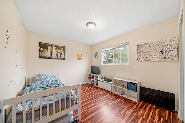 bedroom with dark wood finished floors