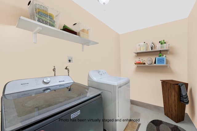 clothes washing area featuring washing machine and dryer and laundry area