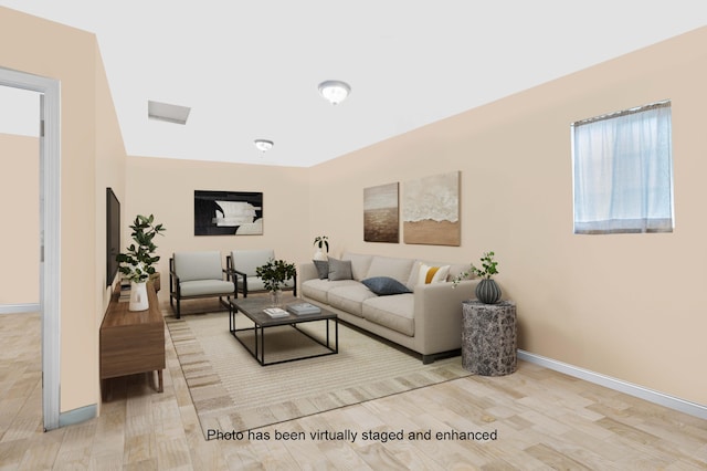 living area featuring baseboards and wood finished floors