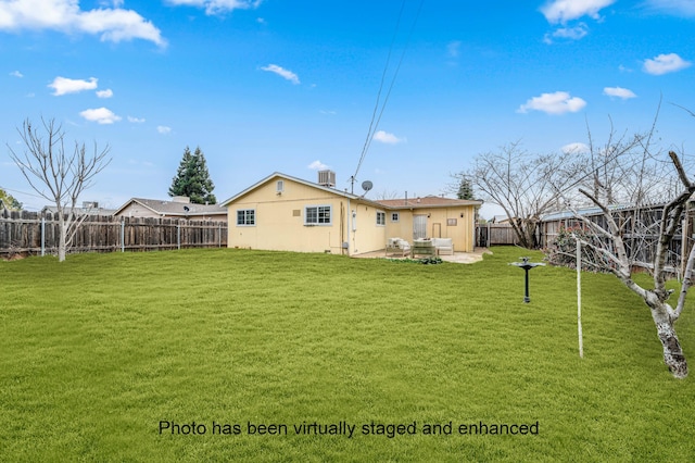 rear view of house with a fenced backyard, central AC unit, a patio, and a yard