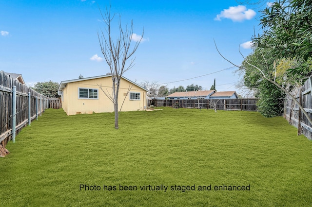 view of yard with a fenced backyard