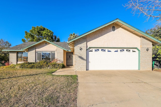 single story home with brick siding, stucco siding, a front yard, a garage, and driveway