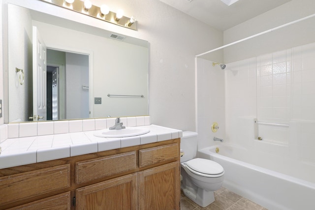 bathroom featuring visible vents, toilet, tub / shower combination, vanity, and tile patterned flooring