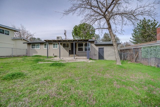 rear view of house with a yard and a patio