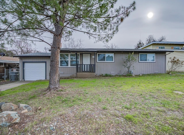 ranch-style house featuring a garage and a front yard