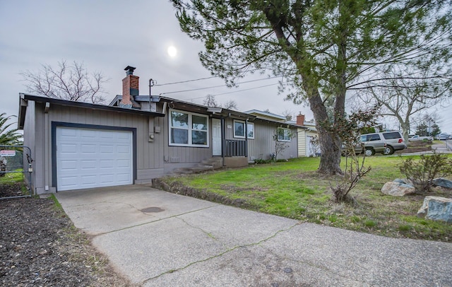 ranch-style home with a garage and a front lawn