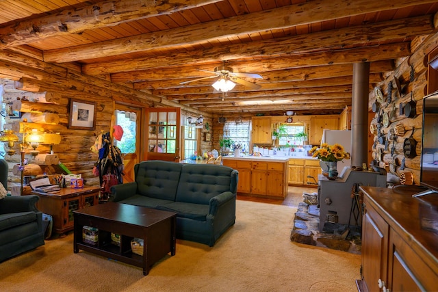 31 Lake Rd, Junction City, CA 96048 - living room featuring a wood stove, rustic walls, ceiling fan, wood ceiling, and beam ceiling