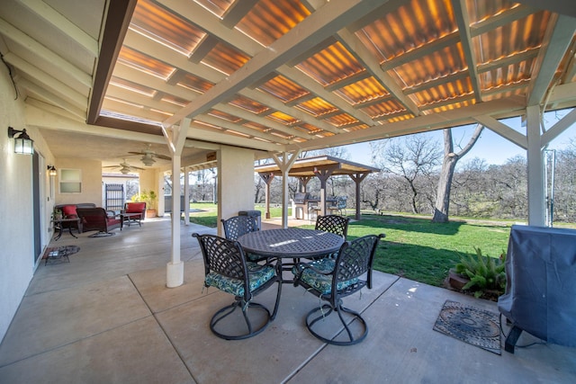 view of patio featuring outdoor dining space, area for grilling, and a ceiling fan