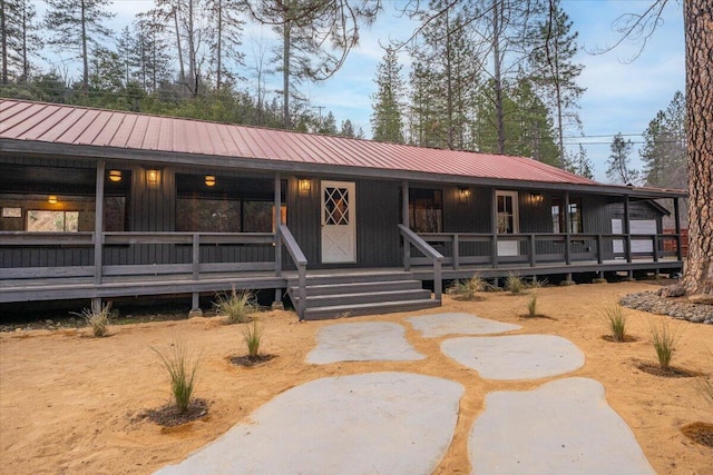 view of front of property with covered porch and metal roof