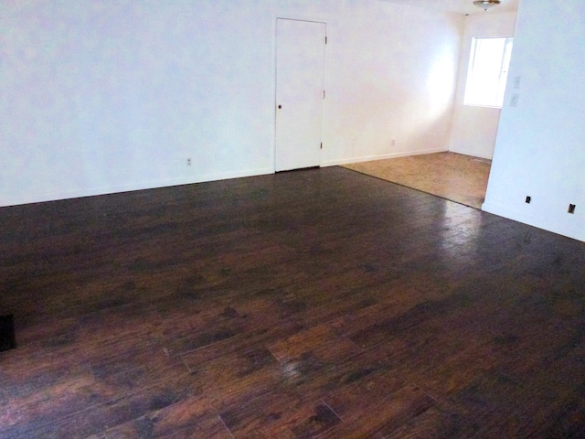 spare room featuring dark wood-type flooring