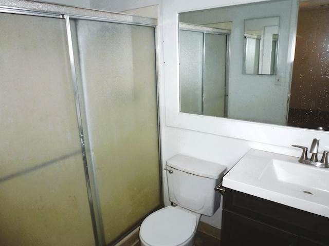 bathroom with vanity, toilet, and walk in shower