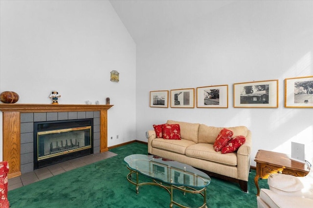 living room featuring a tiled fireplace, vaulted ceiling, and dark colored carpet