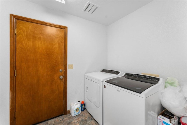 clothes washing area featuring washer and dryer