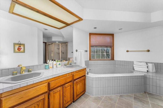 bathroom with vanity, tile patterned flooring, and shower with separate bathtub