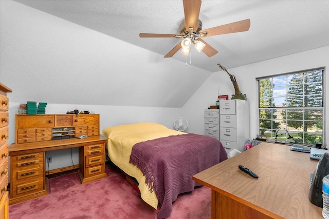 carpeted bedroom featuring lofted ceiling, a textured ceiling, and ceiling fan